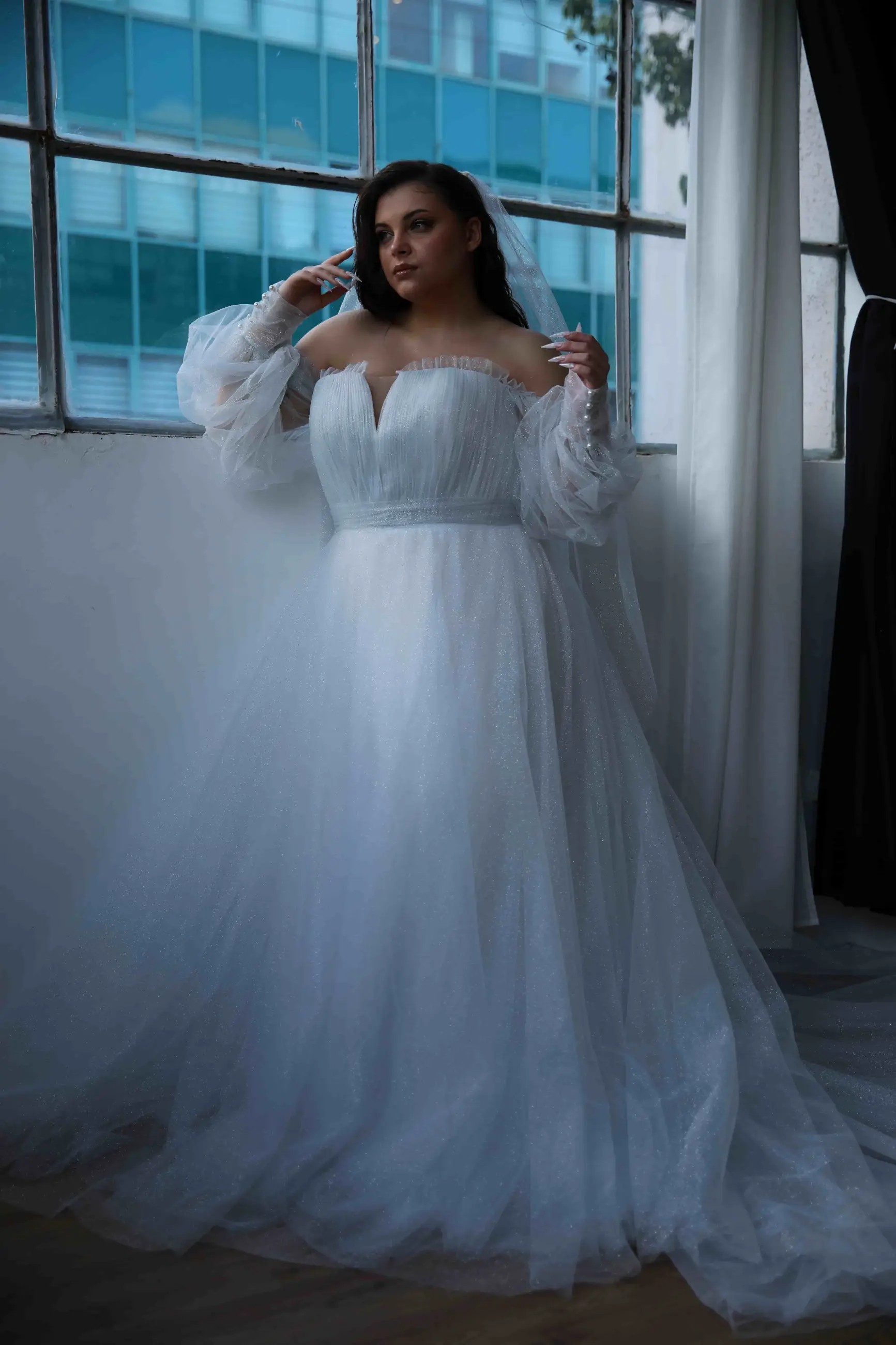 Photo of the model wearing a white bridal gown